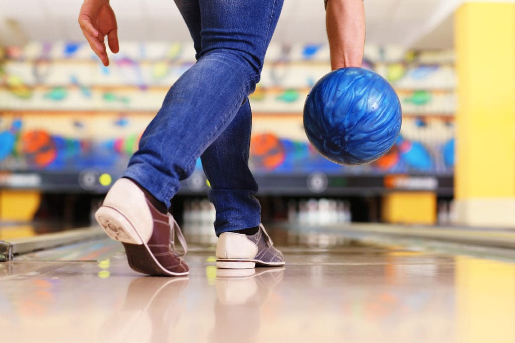 Legs of person bowling